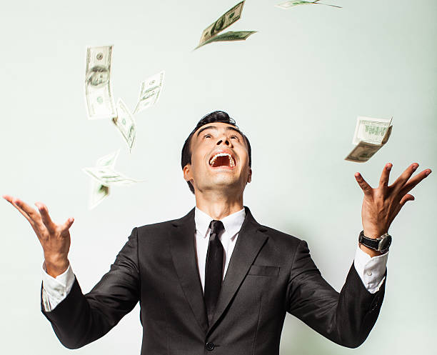 istock Businessman rejoicing for his success with hundred dollar bills. 185915049
