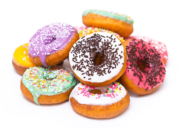bunte frische donuts - sprinkles isolated white multi colored stock-fotos und bilder