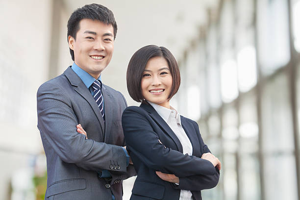istock Two Business People with Arms Crossed 185916282
