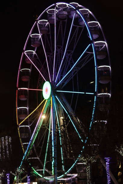 istock Large multi coloured ferris wheel illuminated at night 1859164157
