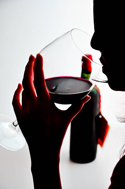 istock woman drinking a glass of red wine 185916537