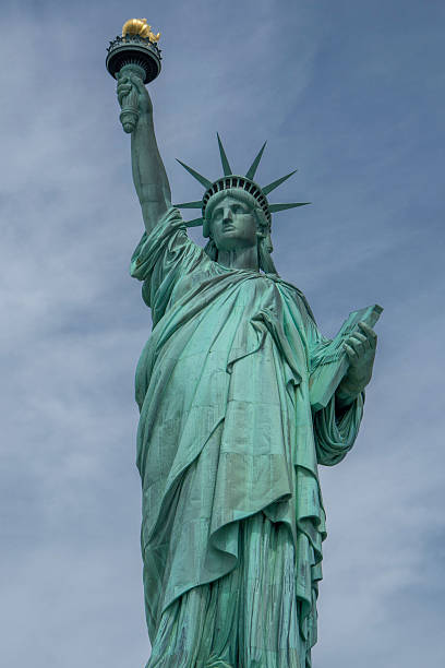 istock Statue of liberty on blue sky and light clouds 185916608