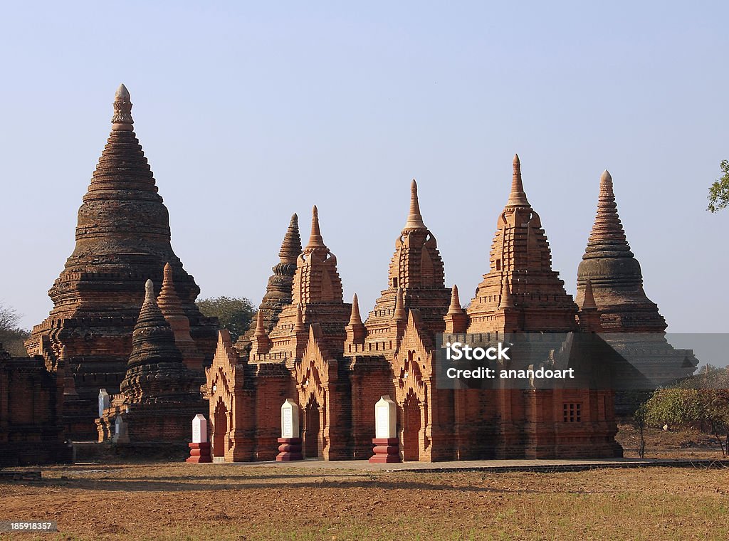 pagodas of bagan The picture shows a group of pagodas of Bagan in the mild evening light. Bagan is a historic royal city in Myanmar with over two thousand preserved pagodas. It is a famous place which attracts tourists. Ancient Stock Photo