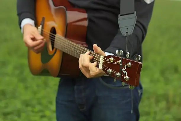 Man playing guitar. Focus on fingers.