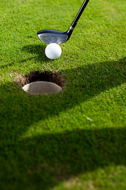 istock Closeup of hole on golf field 185921254