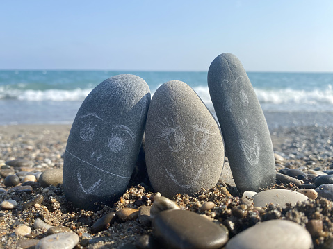 Funny decorated stones on the beach, relax time