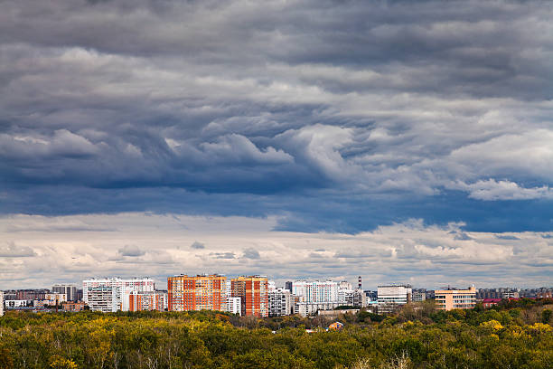 istock dark blue rainy clouds over city in autumn 185924138