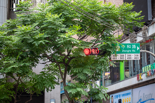 Pedestrian signal lights and roadside shop signs in Taipei, Taiwan