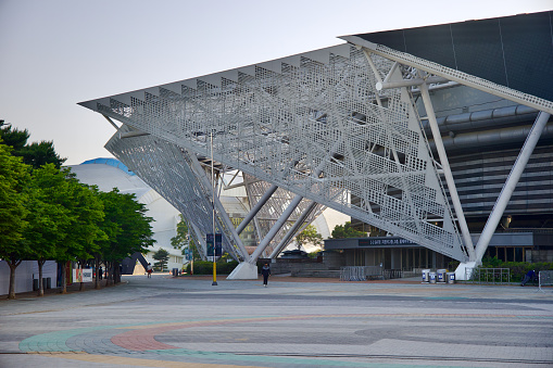 Seoul, South Korea - June 2, 2023: Wide shot of the KSPO Dome, the former '88 Olympics gymnastics facility, now hosting UFC events, Esports contests, and concerts, featuring a white wire mesh awning.