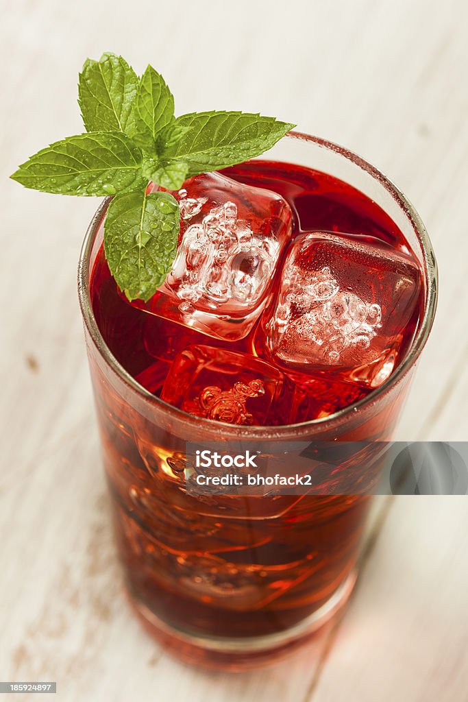 Cold Refreshing Berry Hibiscus Ice Tea Cold Refreshing Berry Hibiscus Iced Tea with Mint Dried Tea Leaves Stock Photo