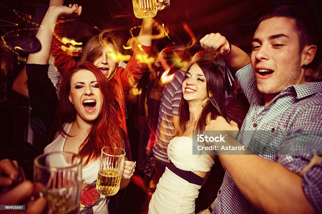 Night out Friends in night club. Dancing, drinking and having fun Dancing Stock Photo
