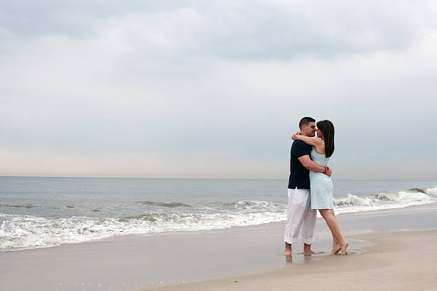 istock Couple embracing on the beach 185925717