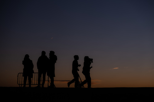 People in silhouette at dusk
