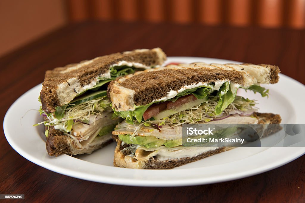 Turkey on Rye Sandwich A deli classic turkey sandwich with avocado on rye bread. Avocado Stock Photo