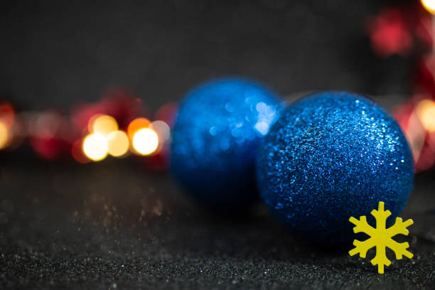 istock Blue glitter baubles with defocused christmast tree lights in the background. defocused abstract holiday backdrop, soft focus close up 1859269891
