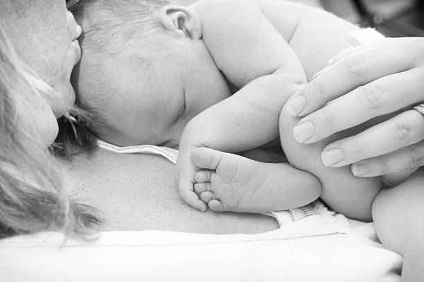 istock Newborn baby holding his foot 185927521