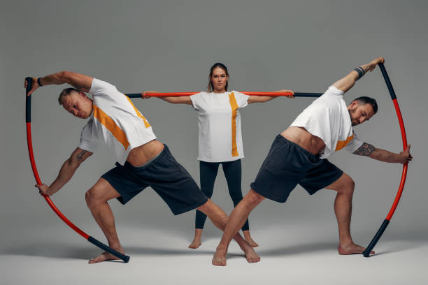 istock People stand together and practice sticks. Karate masters posing with sticks in the studio together. 1859288612
