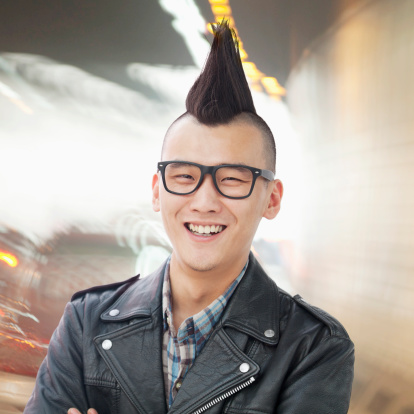 Young man with punk Mohawk smiling