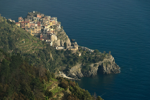 Corniglia to the Cinque Terre. Seascape at sunset time. A fog rises from the sea and creates a magical atmosphere.
