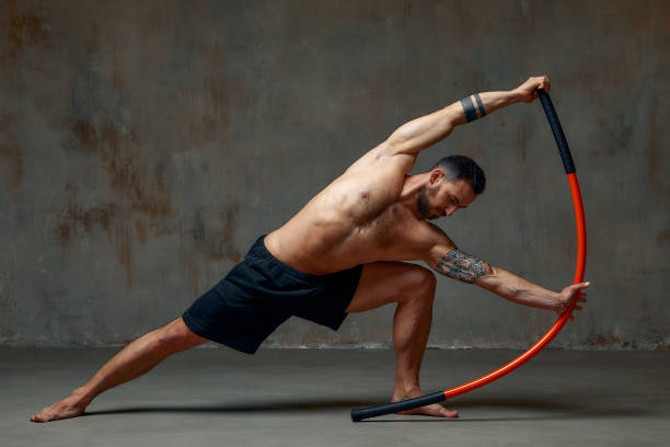 istock A ninja man holds on to a fighting stick and attacks close-up on gray studio background 1859305644