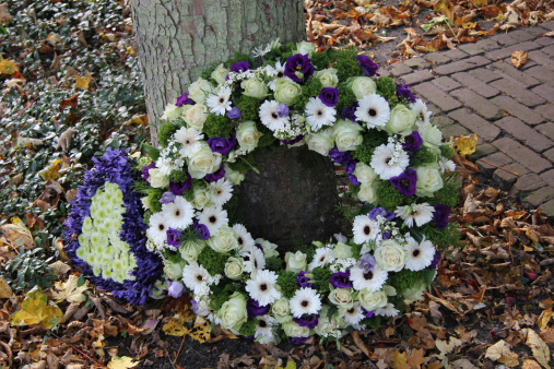 White and purple sympathy flowers in a funeral wreath