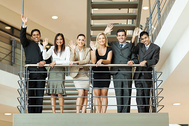 istock business people waving at stairway 185932316