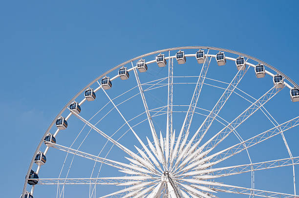 istock Half Cycle of White Ferris wheel and blue sky 185932389