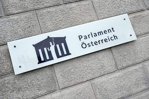 Official sign at a wall of the renovated Austrian Parliament on Ringstrasse in Vienna