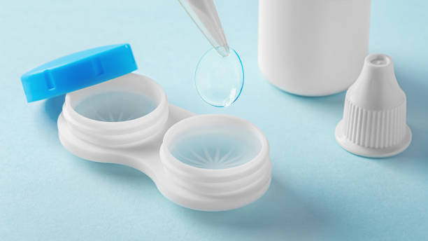 istock Contact lenses with tweezer, container and solution bottle on light blue background 1859326504