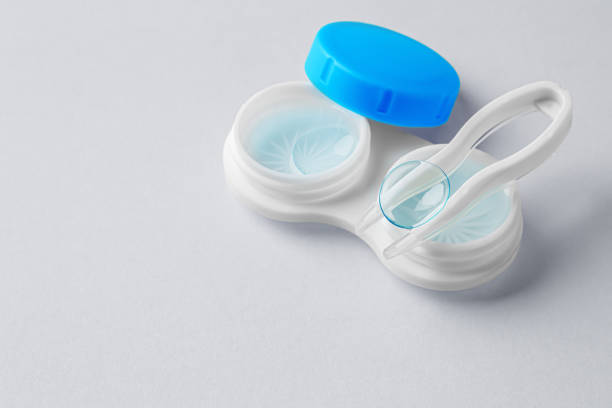 istock Contact lenses with container and tweezer on gray background 1859328372