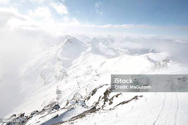 Snow Covered Mountain Under Thick Cloud Stock Photo - Download Image Now - Aster, Awe, Bernese Oberland