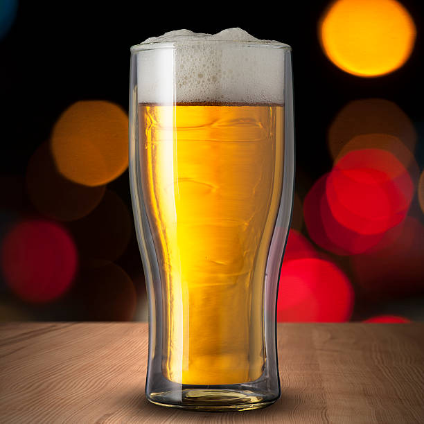 istock Glass of cold beer on wood table 185935435