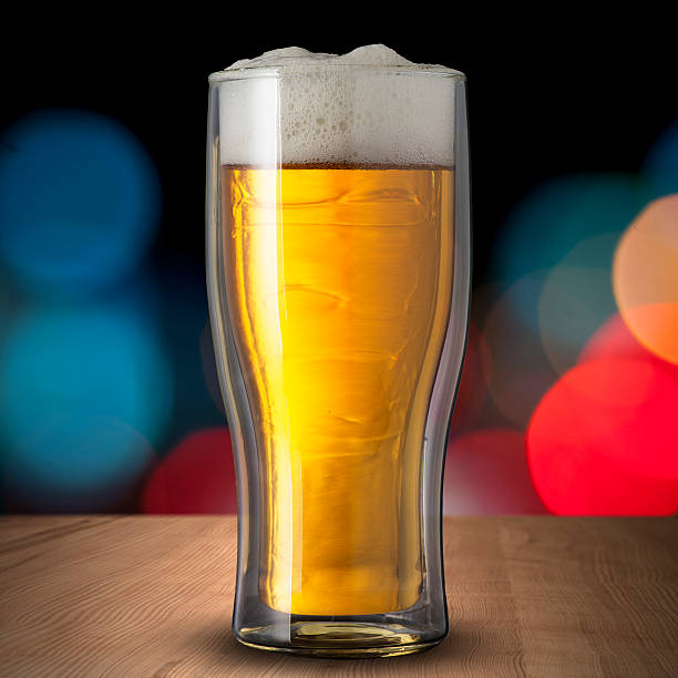 istock Glass of cold beer on wood table 185935546
