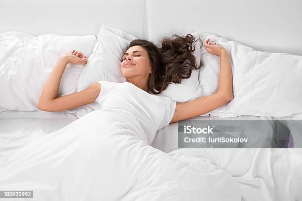 Young Woman Sleeping On The White Linen In Bed Stock Photo - Download Image Now - Sleeping, Bed - Furniture, Women