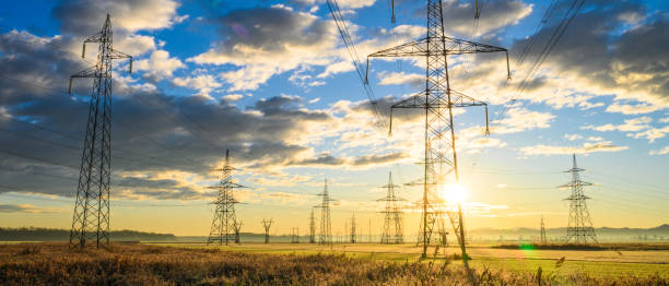 istock Electric power lines at sunrise 1859360102