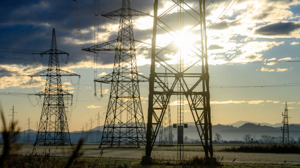 istock Electric power lines at sunrise 1859360103