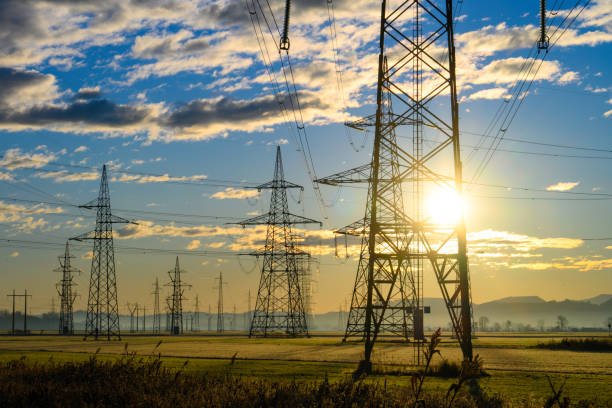 istock Electric power lines at sunrise 1859360120
