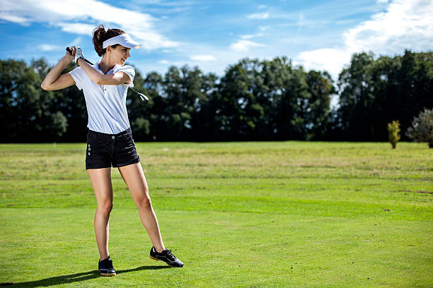 istock Pretty girl playing golf on grass 185939460