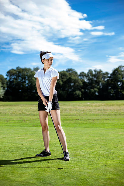 istock Pretty girl playing golf on grass 185939462