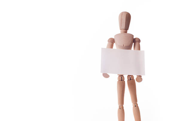 istock wooden manikin holds message board 185940904