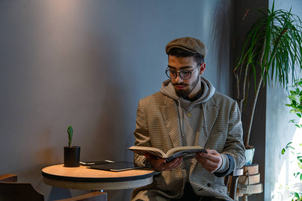 istock Young handsome man in eyewear spending free time in coffee shop. 1859422738