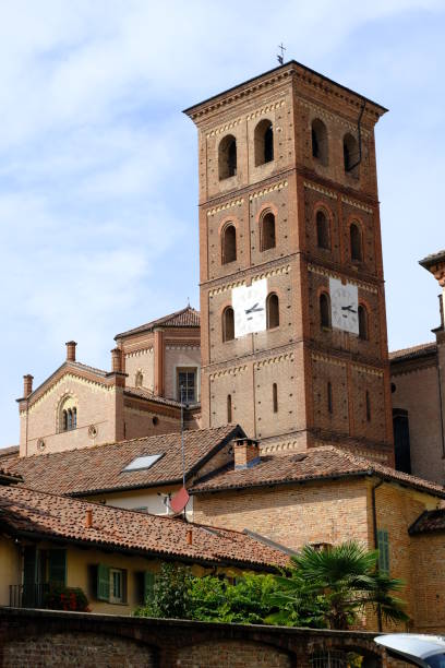 istock Romanesque bell tower in red brick. Ancient medieval bell tower with windows, arches and clock. It has mullioned windows with marble columns. 1859448064