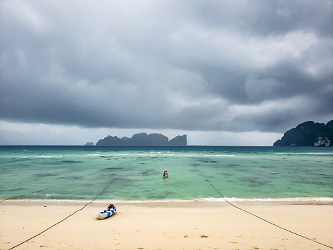 Tropical storm over blue beach in Thailand