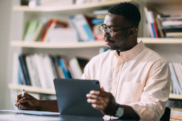 istock Digital Mastery: African-American Man Engaged in Tablet Work 1859476604
