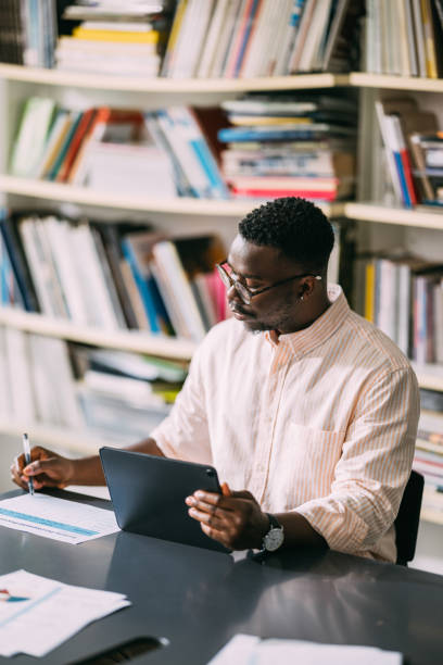 istock Digital Mastery: African-American Man Engaged in Tablet Work 1859476605
