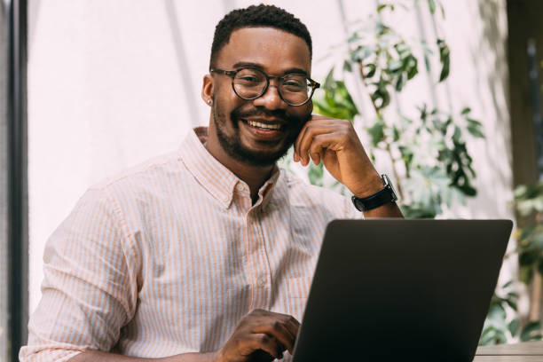 istock Business Casual: African-American Professional in Cafe Workspace 1859476631