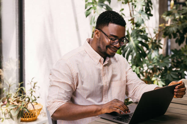 istock Business Casual: African-American Professional in Cafe Workspace 1859476639