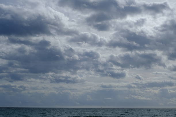 istock Clouds in the sky. Cloudy cumulus cloud on the sky and horizon with sea. 1859483379