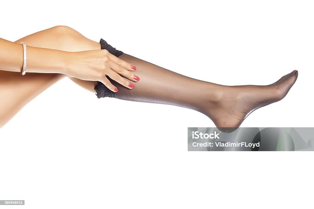 putting on stockings woman putting on nylon stockings Adult Stock Photo