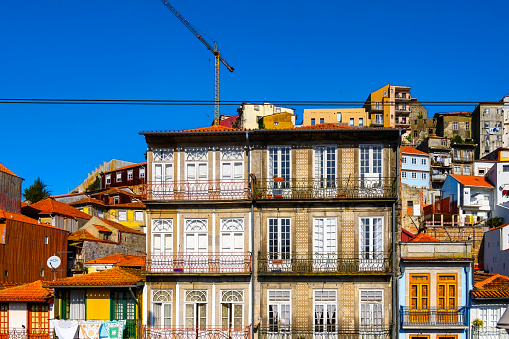 Porto, Portugal - February 16, 2023: Cityscape of traditional old buildings in the waterfront district.